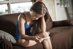 When can you get an abortion? Woman with pregnancy test.